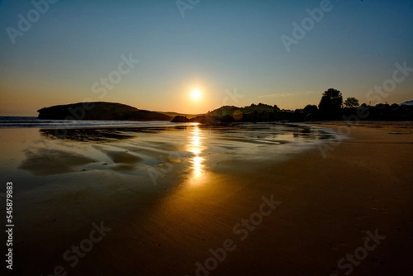 Fototapeta The smooth sand of Barru beach at low toide, in Asturias, Spain, at sunrise