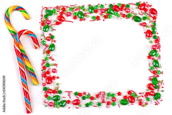 Fototapeta Frame of Christmas colorful candies, cane lollipops, on a white background, close-up, copy space