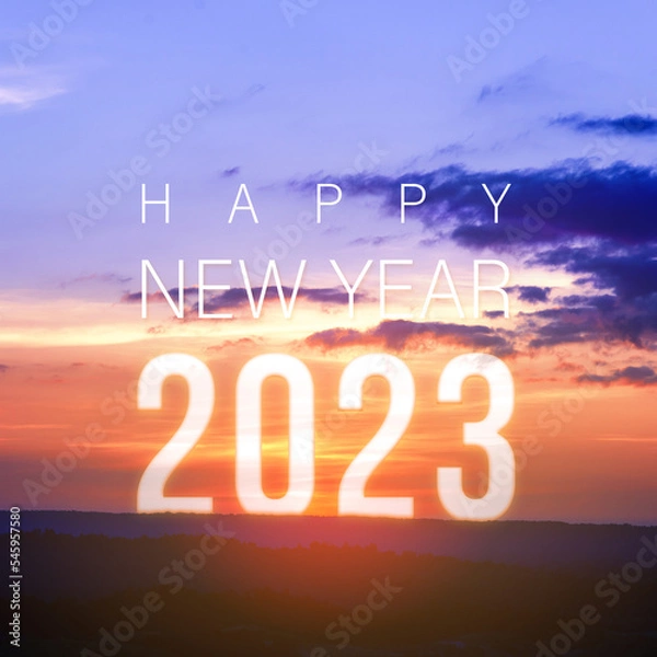 Fototapeta Happy New Year greeting card 2023, Happy New Year 2023 letters on the mountain with sunset on mountains landscape in twilight time. Starting to New Year concept