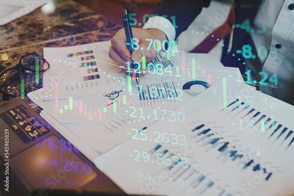 Fototapeta Double exposure of young business man and digital number of stock market background to represent successful in investment marketing. Find out the best solution in business and financial as concept.