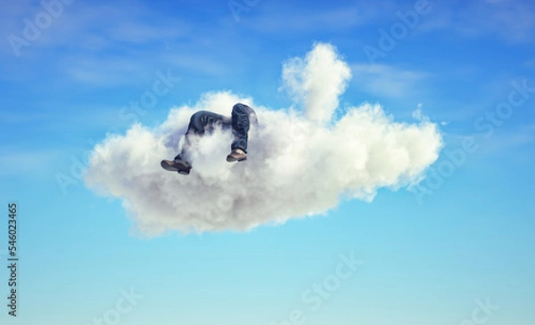 Fototapeta Man lays down on a cloud . Dreaming and aspiration concept.