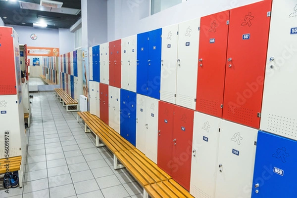 Obraz Red lockers in generic locker room with wooden bench