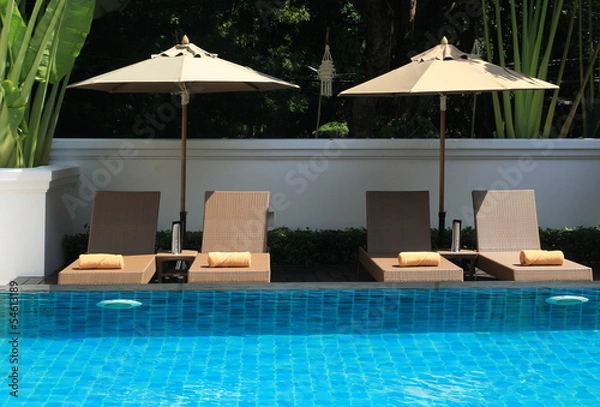 Obraz deck umbrella and swimming pool