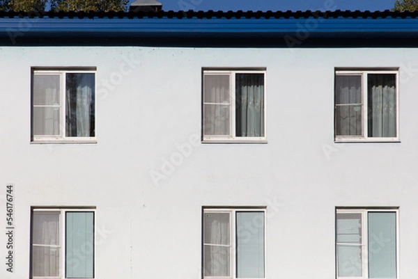 Fototapeta Windows in a white multi-storey building
