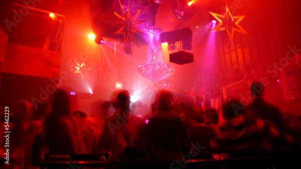 Fototapeta Nightclub scene with christmas decor and dance floor crowd