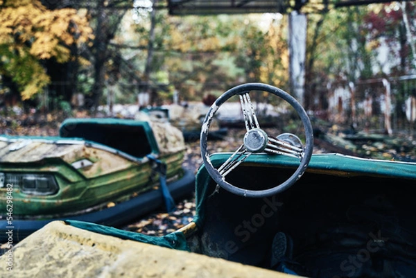Fototapeta Abandoned Amusement Car Ride in Ghost City of Pripyat in Chernobyl Exclusion Zone, Scooter in Autumn Colors