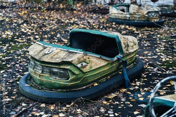 Fototapeta Abandoned Amusement Car Ride in Ghost City of Pripyat in Chernobyl Exclusion Zone, Scooter in Autumn Colors