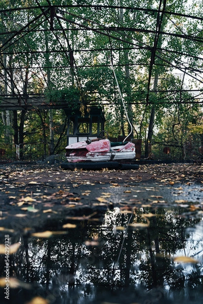 Fototapeta Abandoned Amusement Car Ride in Ghost City of Pripyat in Chernobyl Exclusion Zone, Scooter in Autumn Colors