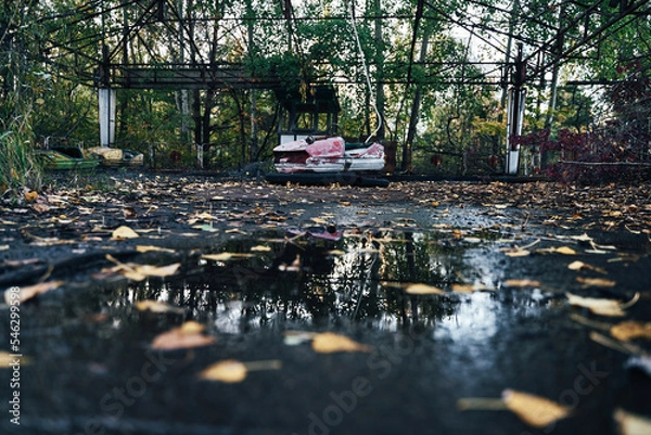 Fototapeta Abandoned Amusement Car Ride in Ghost City of Pripyat in Chernobyl Exclusion Zone, Scooter in Autumn Colors