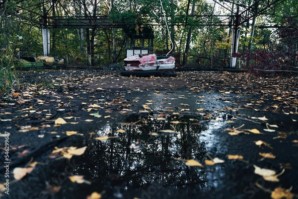 Fototapeta Abandoned Amusement Car Ride in Ghost City of Pripyat in Chernobyl Exclusion Zone, Scooter in Autumn Colors