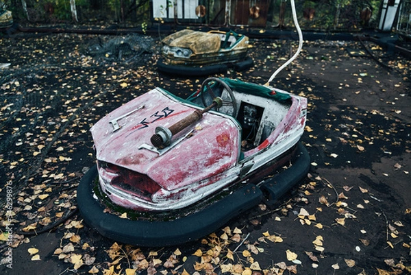 Fototapeta Abandoned Amusement Car Ride in Ghost City of Pripyat in Chernobyl Exclusion Zone, Scooter in Autumn Colors