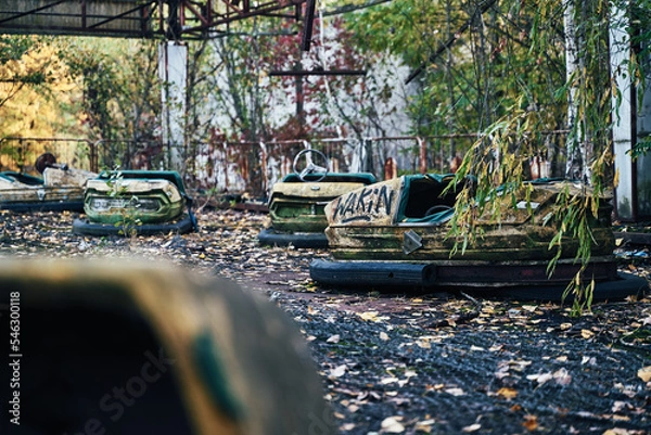 Fototapeta Abandoned Amusement Car Ride in Ghost City of Pripyat in Chernobyl Exclusion Zone, Scooter in Autumn Colors