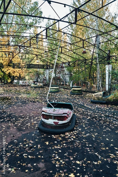 Fototapeta Abandoned Amusement Car Ride in Ghost City of Pripyat in Chernobyl Exclusion Zone, Scooter in Autumn Colors