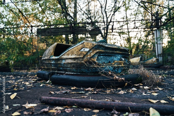 Fototapeta Abandoned Amusement Car Ride in Ghost City of Pripyat in Chernobyl Exclusion Zone, Scooter in Autumn Colors
