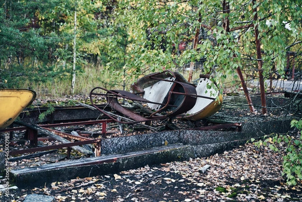 Fototapeta Abandoned Amusement Car Ride in Ghost City of Pripyat in Chernobyl Exclusion Zone, Scooter in Autumn Colors