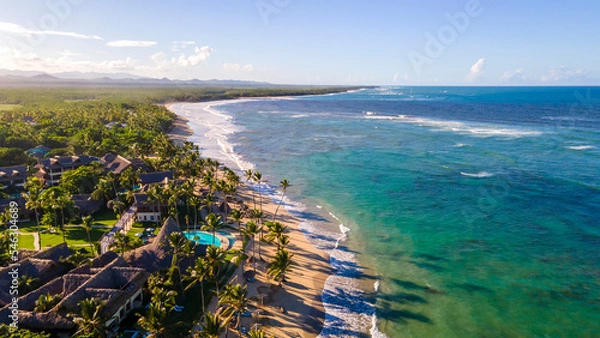 Fototapeta aerial drone shot of a beach on Punta Cana on a beautiful sunny day. the ocean with a crystal blue color that tourist love during vacation 