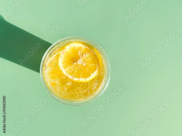 Fototapeta lemon juice, orange juice on green background, summer concept