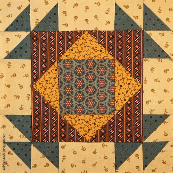 Fototapeta A basic quilt pattern sewn with decorative cotton fabric triangles, rectangles and squares.