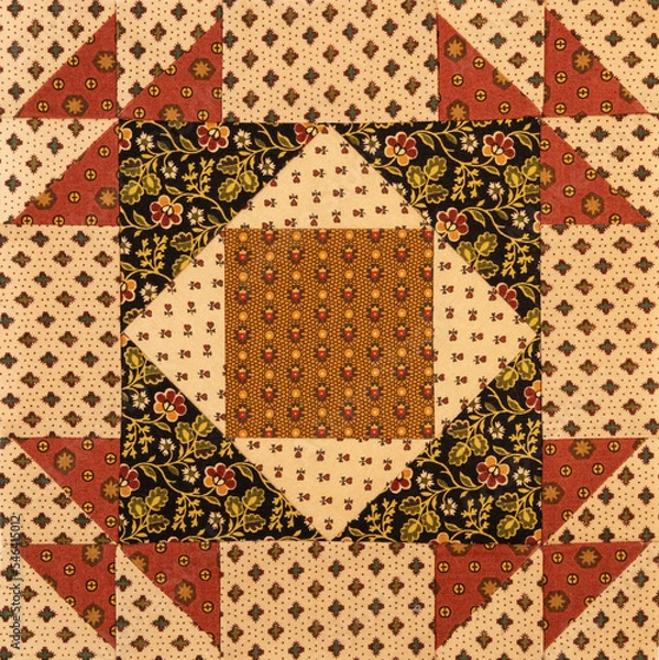 Fototapeta A basic quilt pattern sewn with decorative cotton fabric triangles, rectangles and squares.