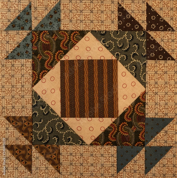 Obraz A basic quilt pattern sewn with decorative cotton fabric triangles, rectangles and squares.