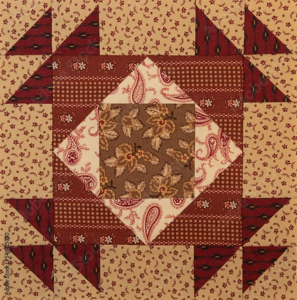 Obraz A basic quilt pattern sewn with decorative cotton fabric triangles, rectangles and squares.