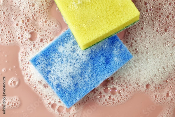 Obraz soap foam and two sponges on a pink background