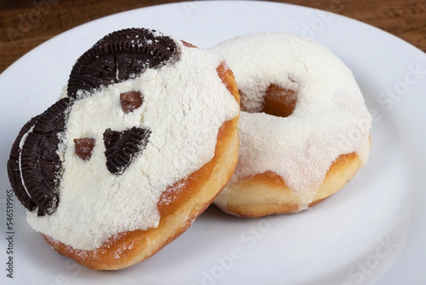 Obraz Sweet donuts with cream and powdered milk frosting and another fun teddy bear themed donut.