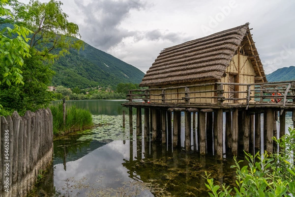Fototapeta A hut next to a lake in an archaeological site in Lago di lago, Italy
