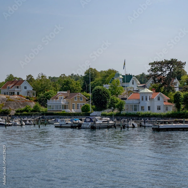 Fototapeta Boats at a pier next to a small village in Göteborg, Sweden