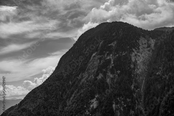 Obraz A rugged hill in front of a clouded sky in alps, Sauris, Italy