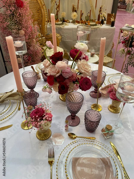 Fototapeta Festive table setting in pink purple red style with candles and flowers.