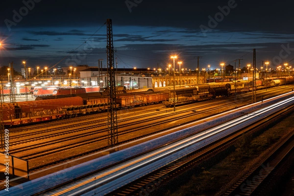 Obraz Cargo train station in Mannheim at night with moving train
