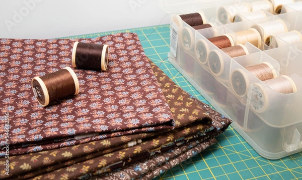 Fototapeta Sewing thread, colored fabric with various patterns and colors for sewing, quilting and crafts.