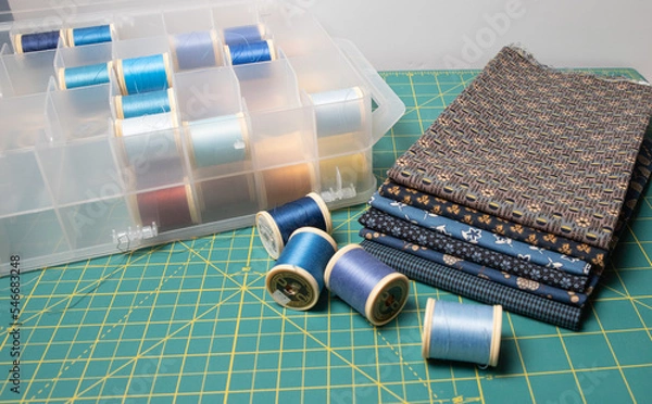 Fototapeta Sewing thread, colored fabric with various patterns and colors for sewing, quilting and crafts.