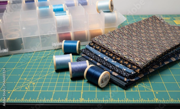 Fototapeta Sewing thread, colored fabric with various patterns and colors for sewing, quilting and crafts.