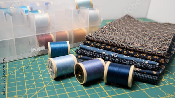 Fototapeta Sewing thread, colored fabric with various patterns and colors for sewing, quilting and crafts.