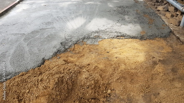 Fototapeta Pour the cement onto the compacted path to be a walkway.