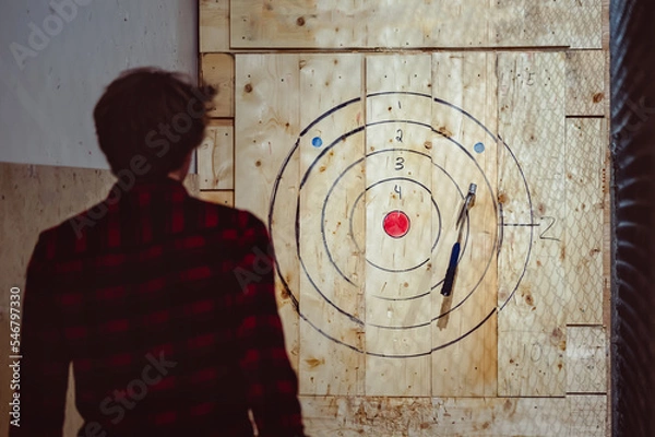 Fototapeta throwing axe for fun in a cage