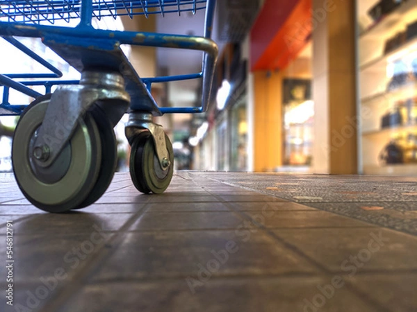 Obraz Shopping cart photographed from below in the mall against a blurry background