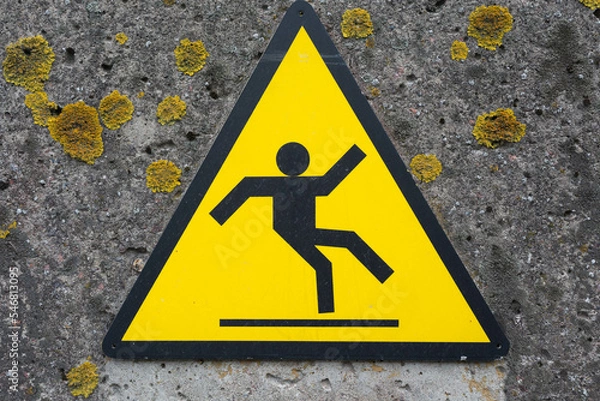 Fototapeta Sign beware slippery floor on a wall