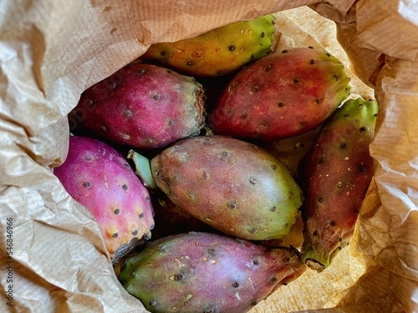Fototapeta Prickly pear cactus colorful fresh ripe whole and cut fruits in brown paper bag.