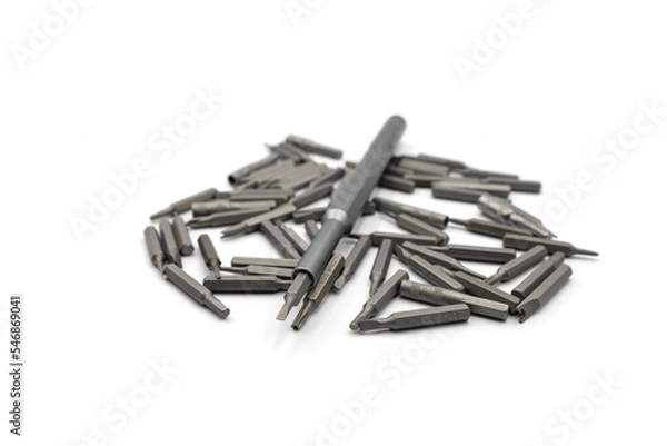 Fototapeta Screwdriver and macnite bits isolated on white background. Changeable screwdriver bits isolated white