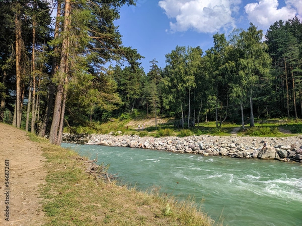 Fototapeta Arkhyz, Karachay-Cherkessia, Russia - August 24, 2022: View of the Zelenchuk River in the village of Arkhyz against the backdrop of the Caucasus Mountains