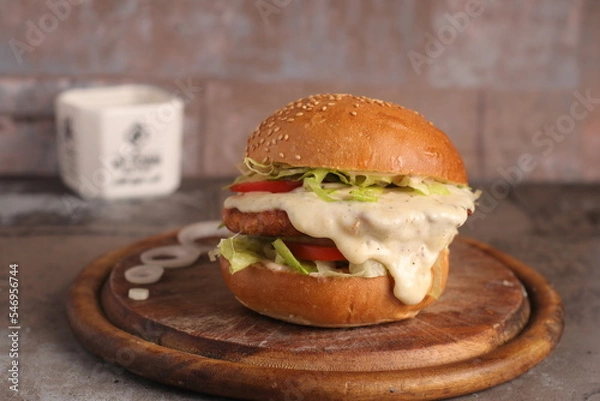 Fototapeta Homemade cheeseburger on an upscale table for lunch and dinner