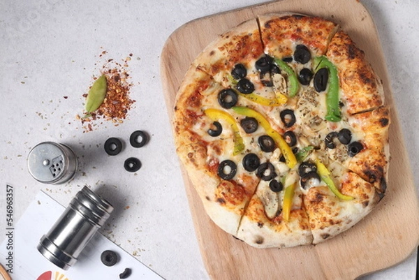 Fototapeta Delicious pizza with a sophisticated background of cheese and vegetables