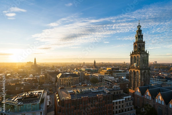 Fototapeta The sun setting over the historical city centre of Groningen and the Martinitoren on a beautiful afternoon.