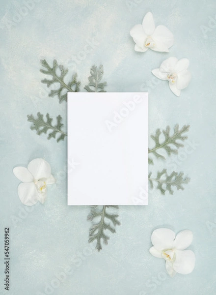 Fototapeta Floral flat lay with blank stationery card and fresh white orchid flowers and botanical elements