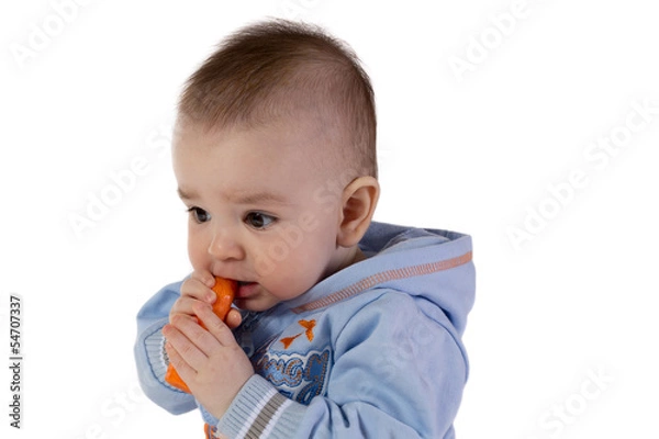 Obraz Smiling baby eats carrot