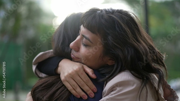 Fototapeta Sympathetic woman hugging friend with EMPATHY and SUPPORT. Friendship concept between two best friends