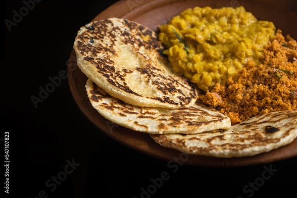 Fototapeta Sri Lankan style coconut roti bread with coconut sambol and dhal curry.